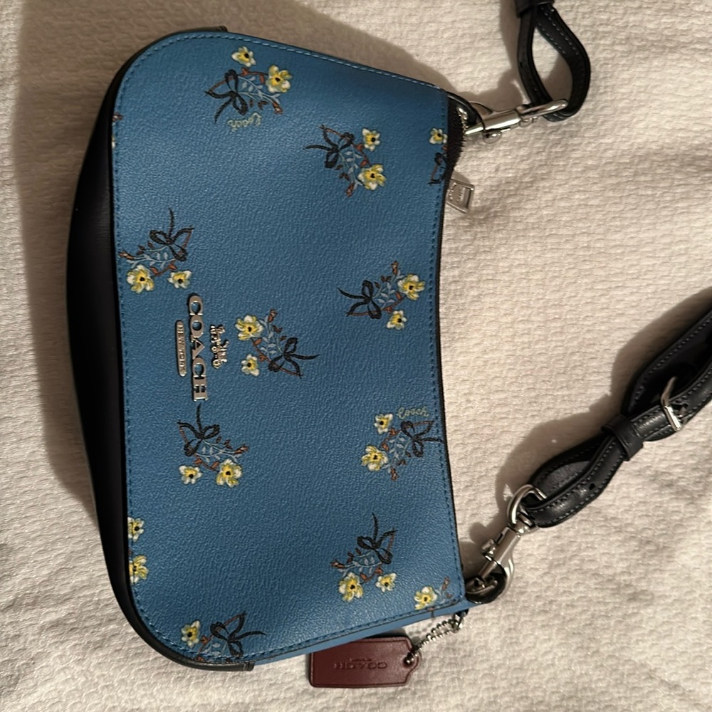 Light blue Coach purse with flower, and shoulder strap